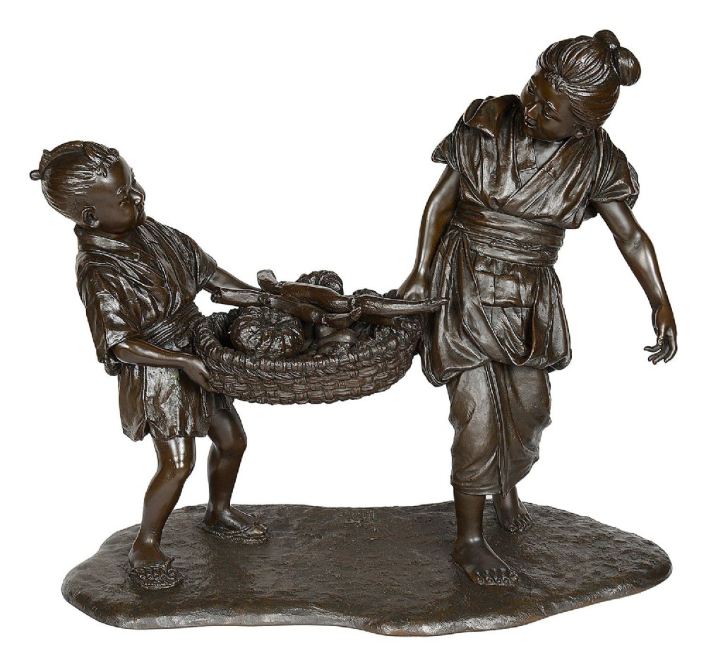 A dark brown patinated bronze sculpture depicting a Japanese woman and child carrying a woven basket filled with produce across a textured base.