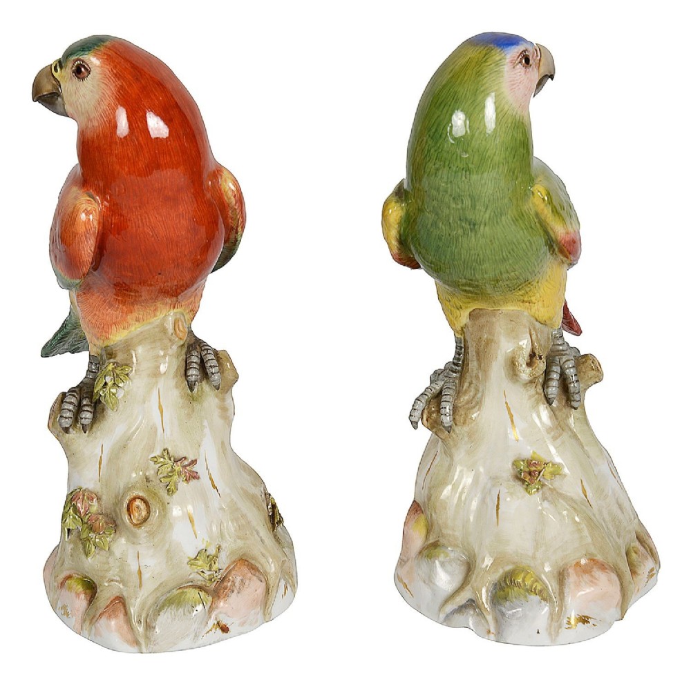 A pair of late 19th-century Meissen porcelain parrots with brightly coloured plumage perched on sculpted tree stump bases. View II
