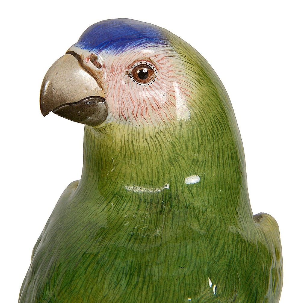 A pair of late 19th-century Meissen porcelain parrots with brightly coloured plumage perched on sculpted tree stump bases. View VI