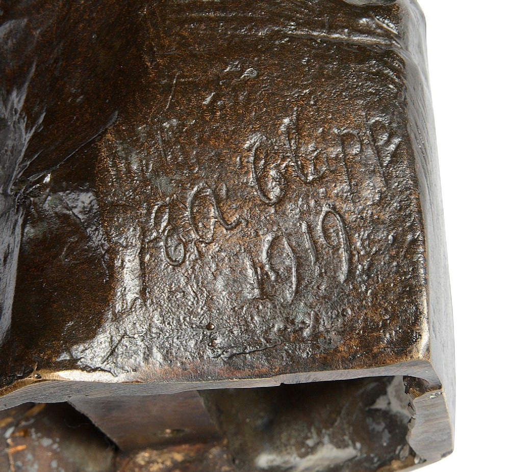 A dark brown patinated bronze sculpture depicting two young children near a rock formation, with one standing above holding a towel and the other crouching at the base. View VII