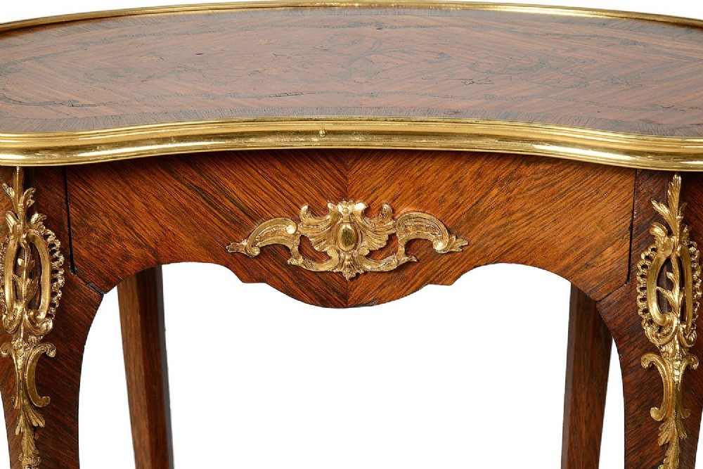 A kidney-shaped French marquetry side table featuring cabriole legs, an lower tier shelf, and metal edge mounts. View V