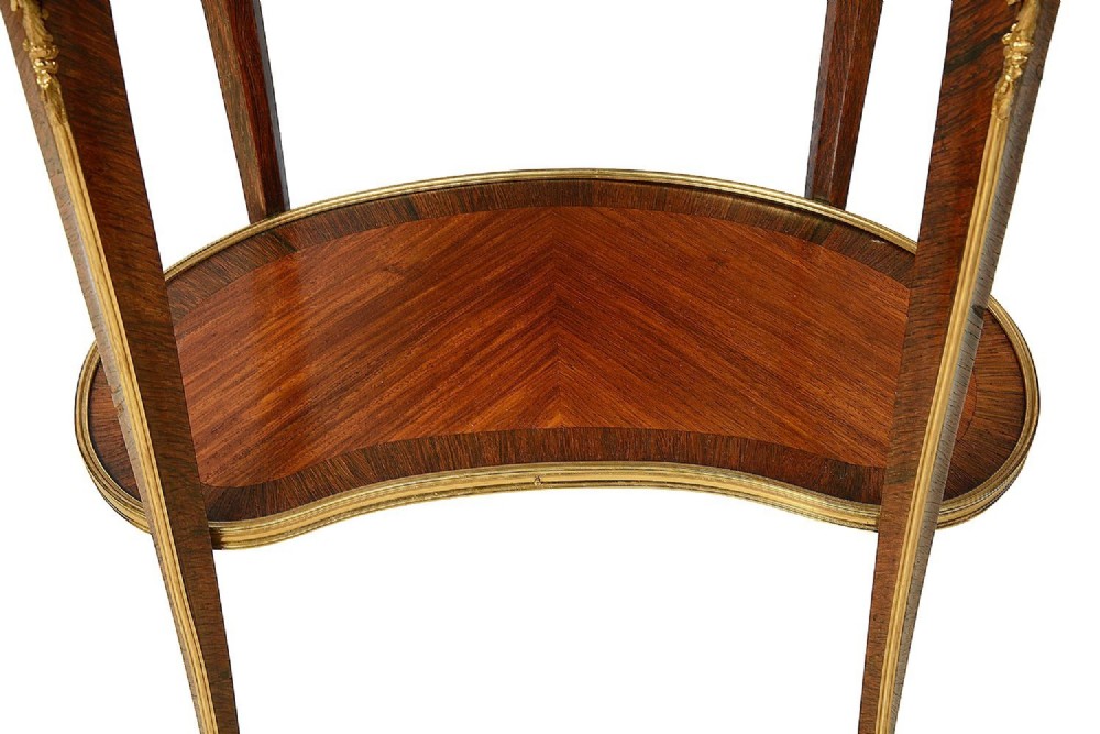 A kidney-shaped French marquetry side table featuring cabriole legs, an lower tier shelf, and metal edge mounts. View VIII