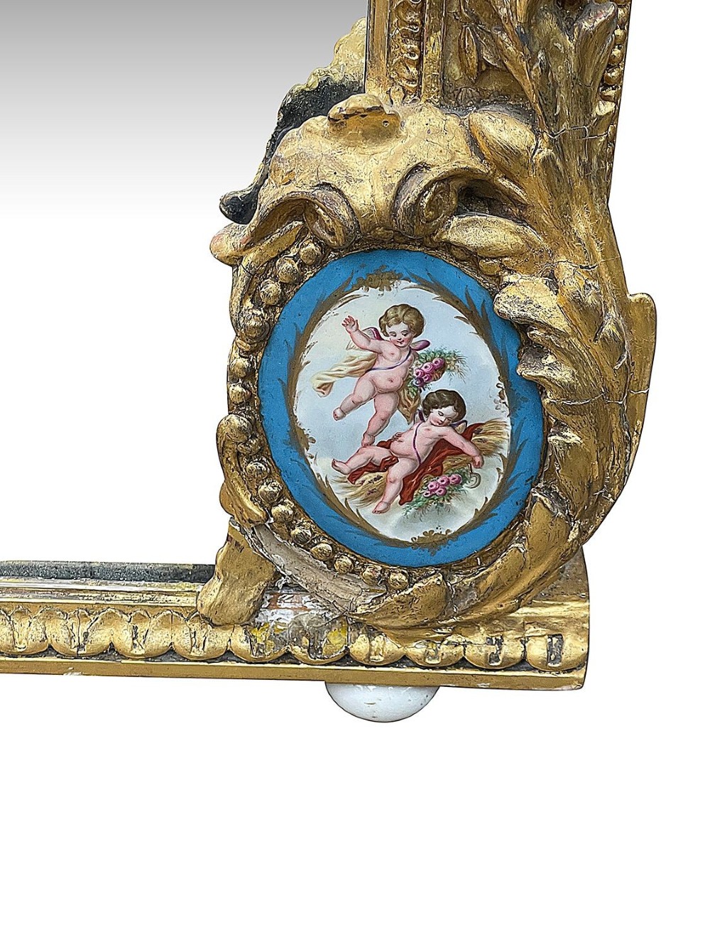 A large gilt-bronze wall mirror featuring an arched crest with sculpted putti, foliage mouldings, and oval Sevres porcelain plaques set along the frame. View VIII