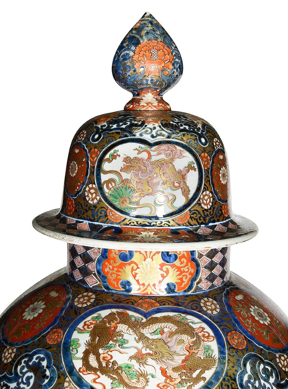 A pair of large 19th-century Japanese Imari porcelain lidded vases featuring painted reserves depicting figures in garden settings, surrounded by cobalt blue, orange, green, and gold patterns. View IV