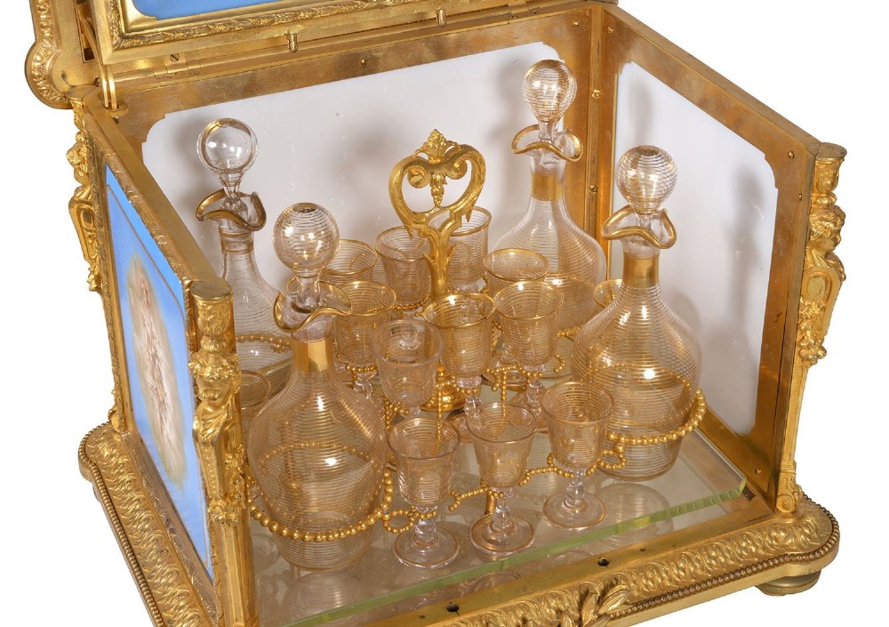 A 19th-century French ormolu and light blue porcelain decanter box open to display glass decanters and matching glasses. View IV