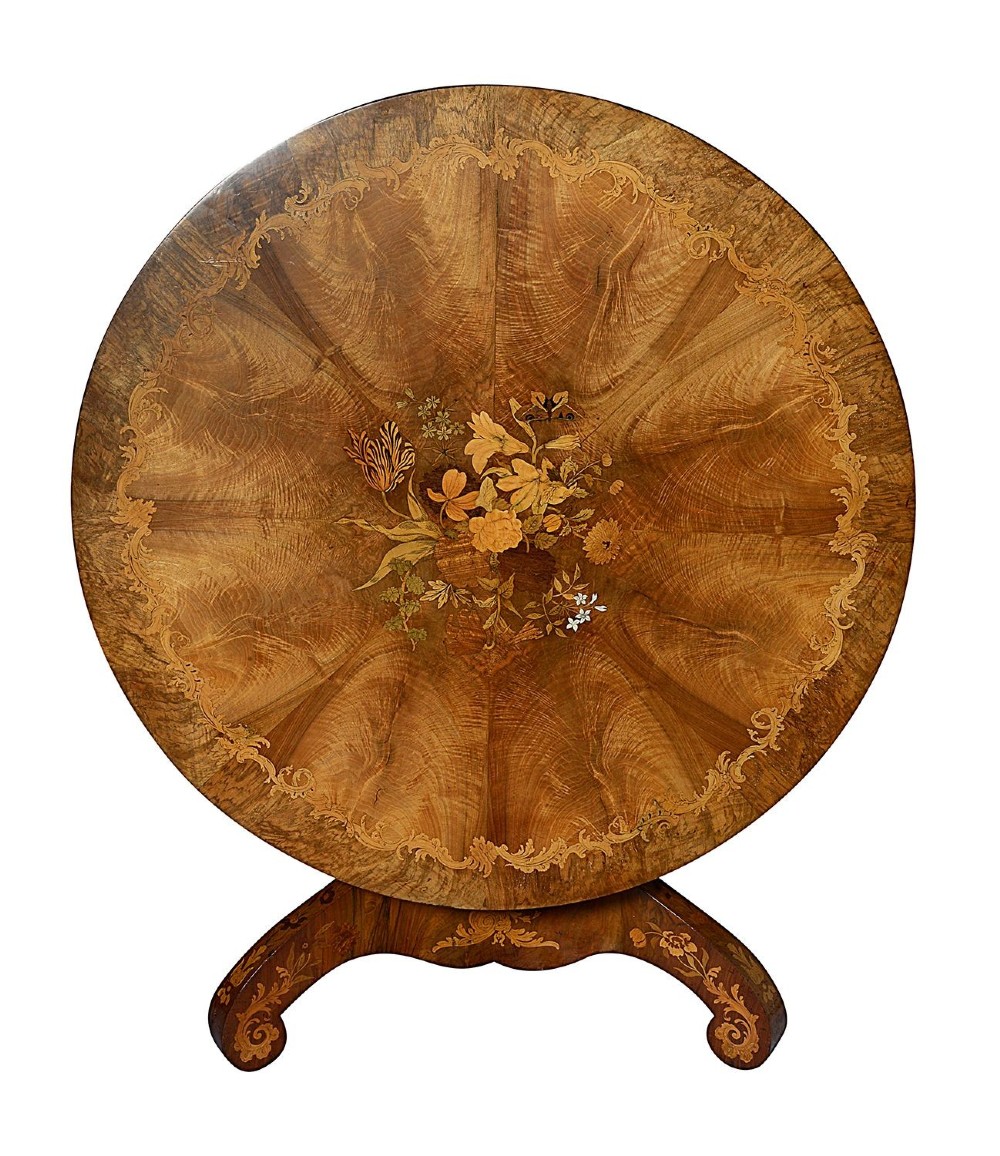 A circular Victorian walnut centre table featuring radial segment veneers, intricate floral marquetry, and a carved pedestal base with scroll feet. View II