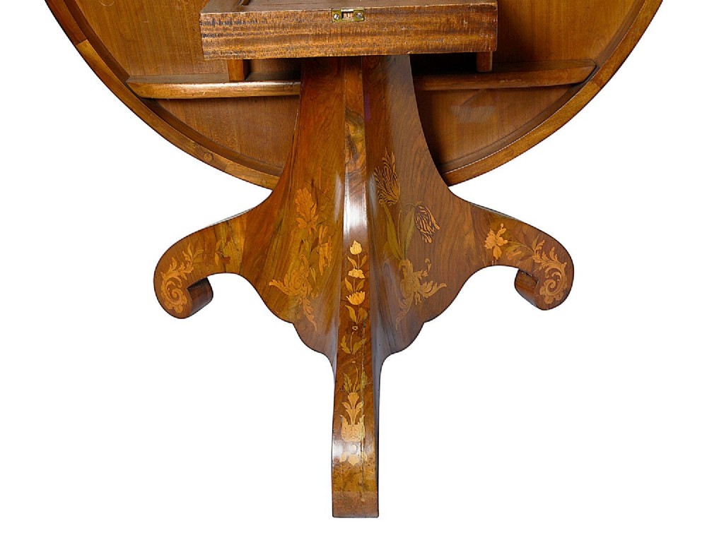 A circular Victorian walnut centre table featuring radial segment veneers, intricate floral marquetry, and a carved pedestal base with scroll feet. View VI