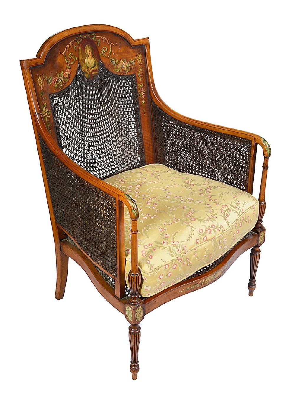 A pair of late Victorian Sheraton Revival satinwood bergere armchairs featuring hand-painted floral motifs, portrait medallions, caned backs, and yellow fabric seats. View VI