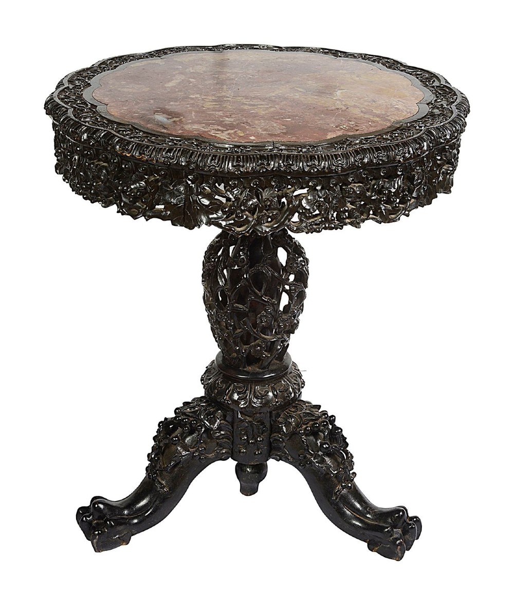 A nineteenth-century Chinese carved dark hardwood side table featuring a circular pink marble inset top, pierced openwork frieze, reticulated central pedestal, and tripod clawed feet. View II