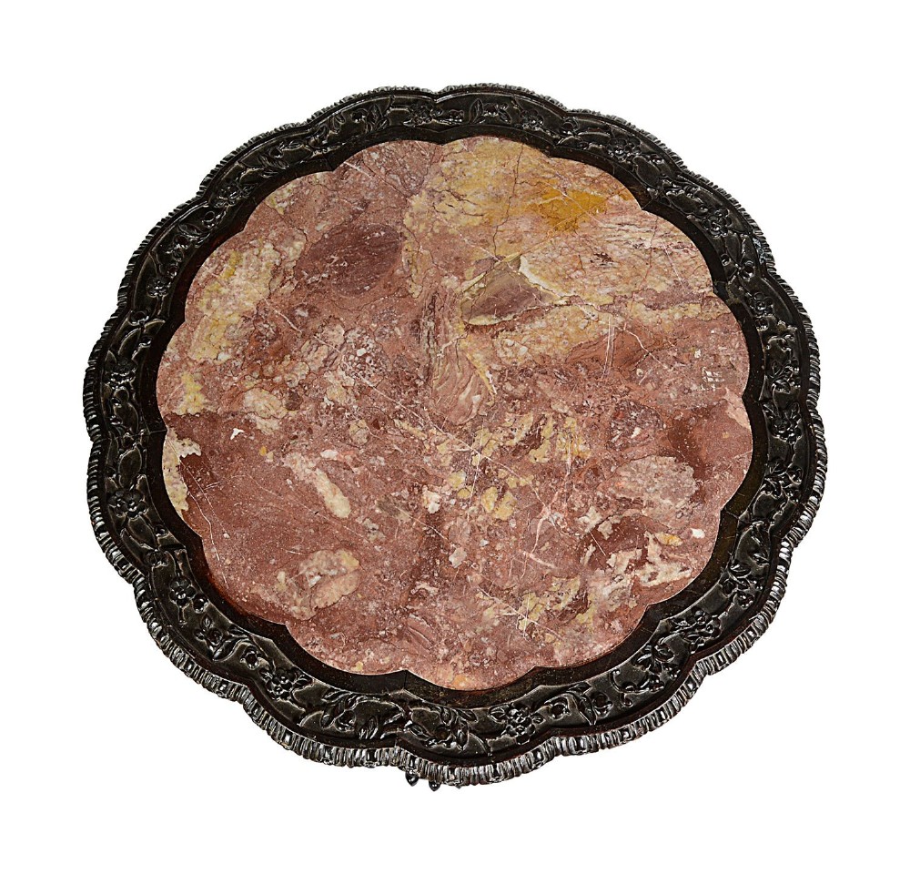 A nineteenth-century Chinese carved dark hardwood side table featuring a circular pink marble inset top, pierced openwork frieze, reticulated central pedestal, and tripod clawed feet. View III