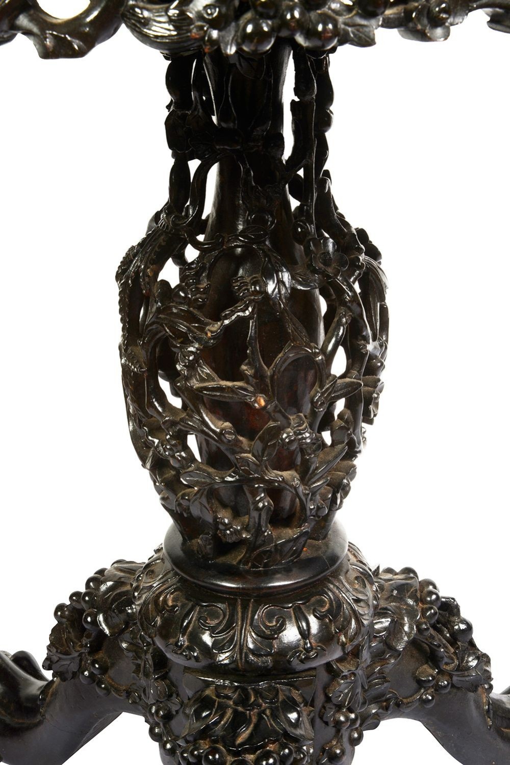 A nineteenth-century Chinese carved dark hardwood side table featuring a circular pink marble inset top, pierced openwork frieze, reticulated central pedestal, and tripod clawed feet. View VII