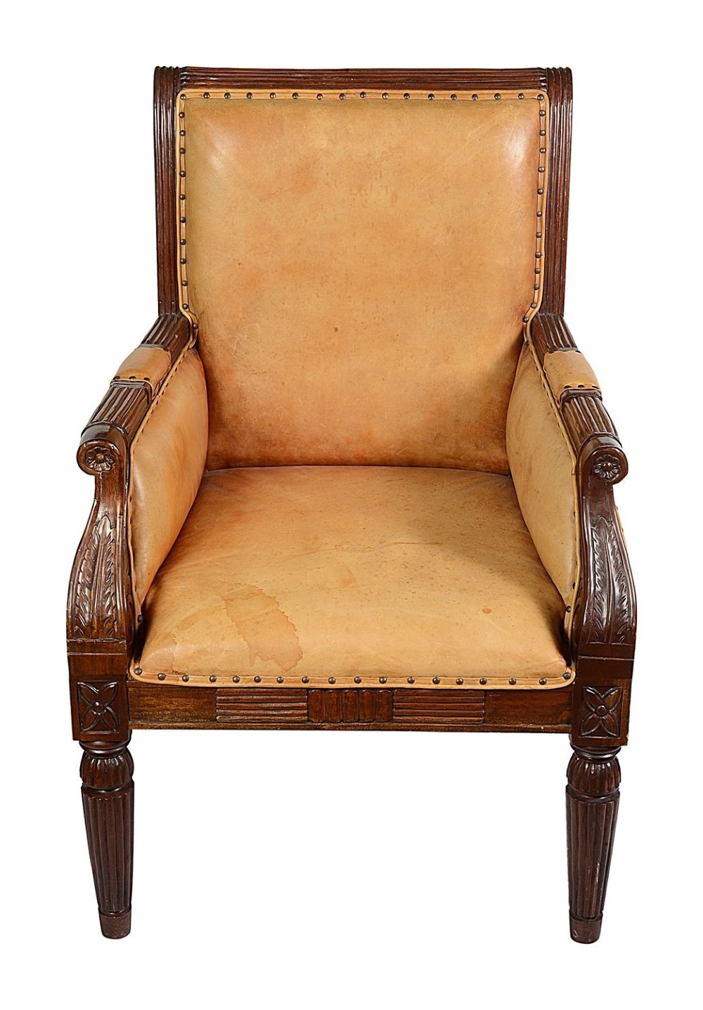 A pair of Regency style dark mahogany library armchairs upholstered in tan leather with brass stud trimming and reeded carved legs. View II