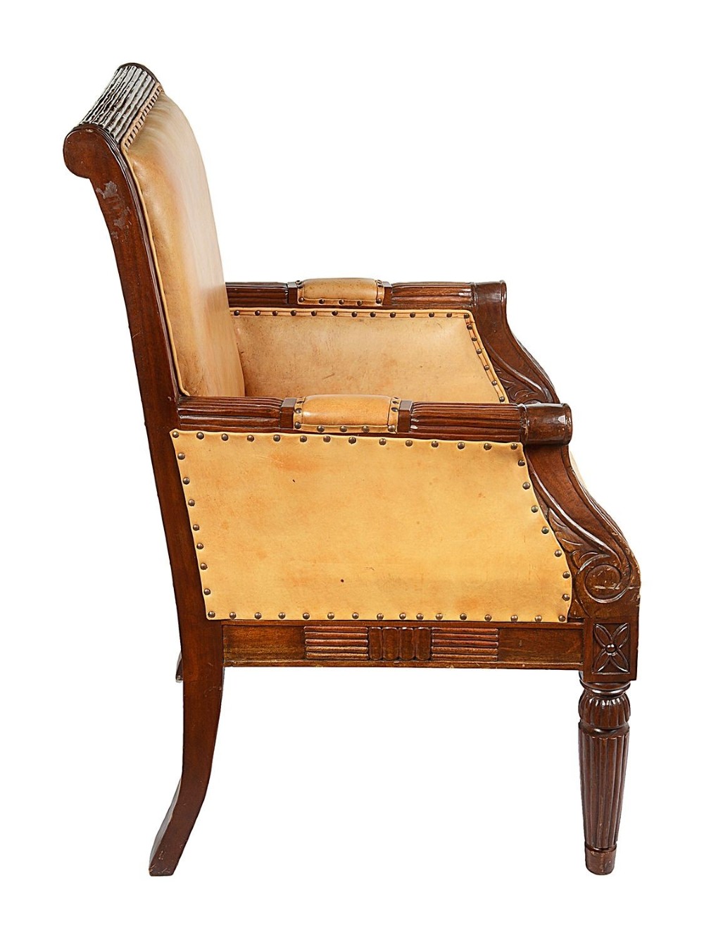 A pair of Regency style dark mahogany library armchairs upholstered in tan leather with brass stud trimming and reeded carved legs. View VIII