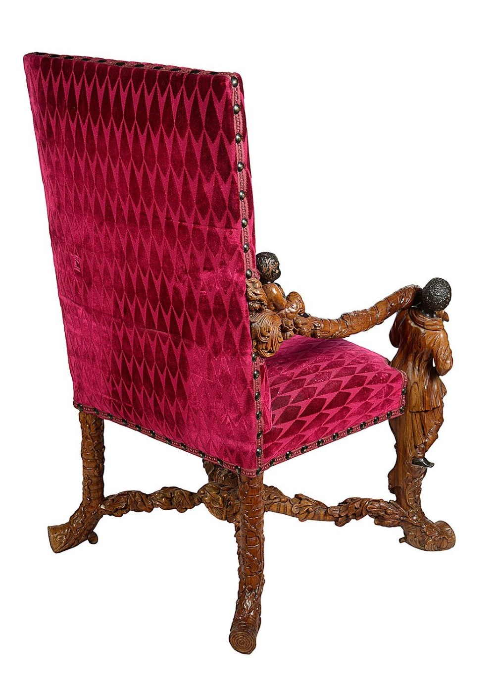 An ornate Venetian style armchair with high back red diamond velvet upholstery and detailed carved wooden human figures forming the armrests and legs. View X