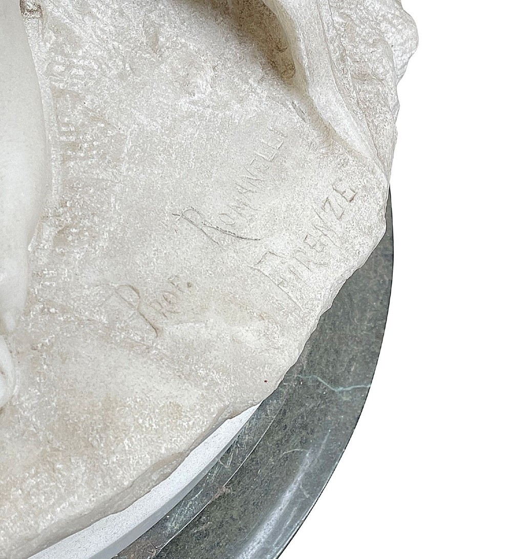 A 19th-century white Carrara marble statue depicting a classical female figure in draped robes with a winged putto at her side. View V