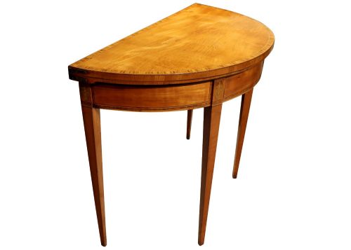 fig 1. A George III satinwood demi-lune card table featuring kingwood crossbanding and square tapered legs.
