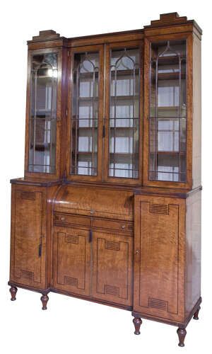 fig 1. A Regency mahogany breakfront secretaire bookcase with glazed doors, satinwood veneers, and ebony inlay detail.
