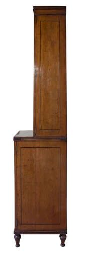 fig 3. A Regency mahogany breakfront secretaire bookcase with glazed doors, satinwood veneers, and ebony inlay detail.
