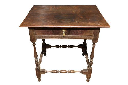 fig 1. An 18th-century George II solid oak side table featuring a single drawer with a brass teardrop pull, turned legs, and stretchers.