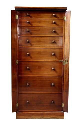 fig 2. A tall mid-19th century mahogany Wellington chest featuring eight graduated drawers with turned wooden knobs and a side-locking hinged pilaster.