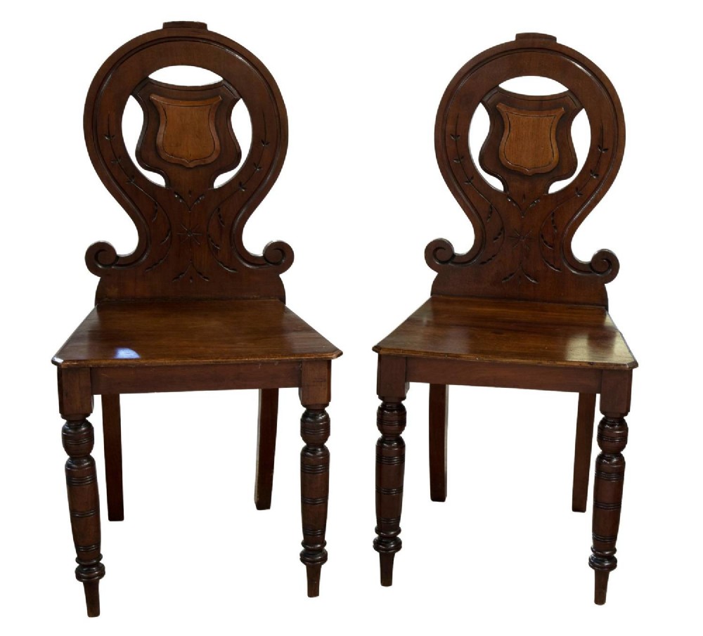A Pair of Victorian mahogany hall chairs