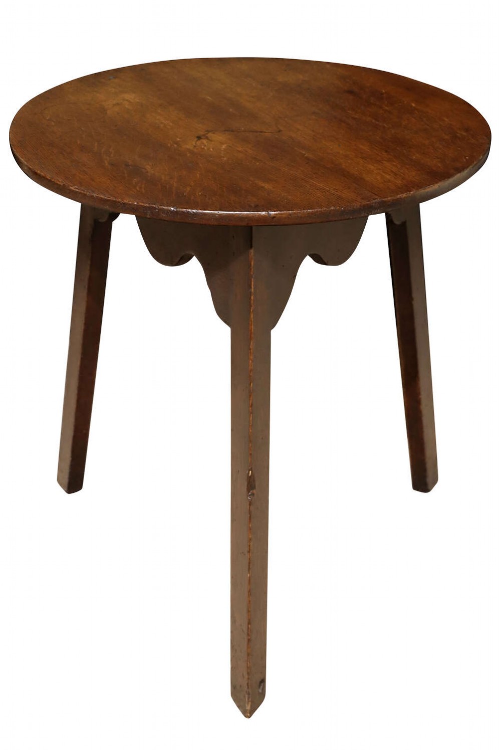 An 18th-century English oak cricket table featuring a flat circular top, three straight splayed legs, and shaped wooden aprons underneath.