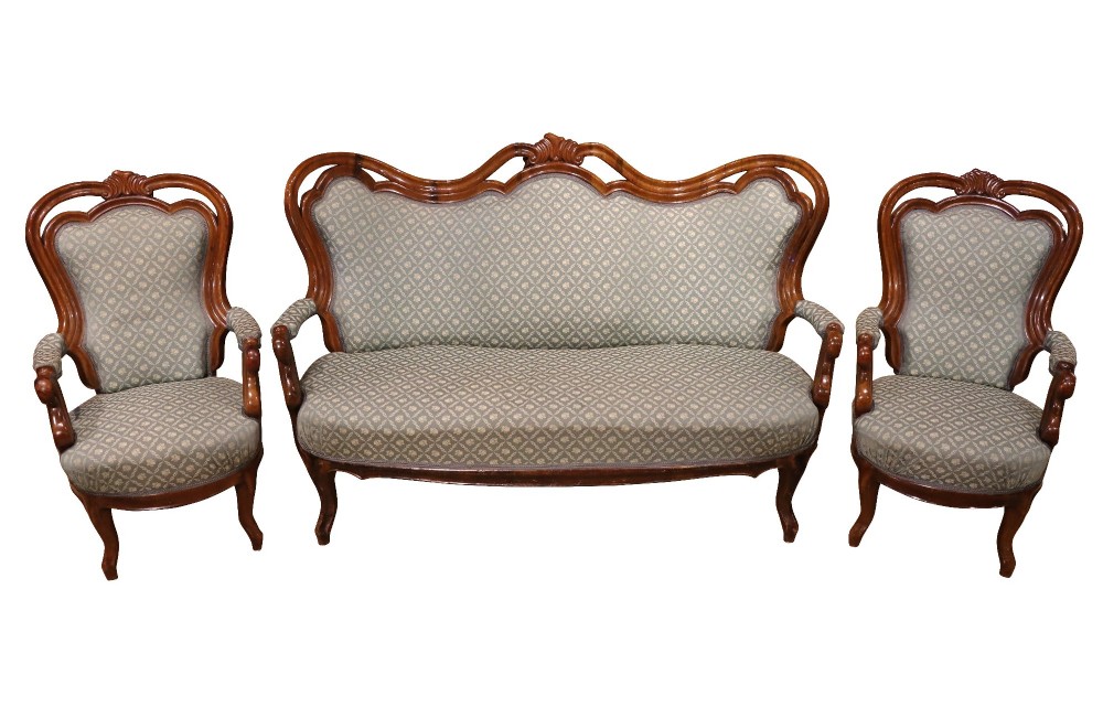 A late 19th-century three-piece walnut salon suite featuring a central settee and two matching armchairs upholstered in patterned sage green fabric with carved serpentine frames. View II