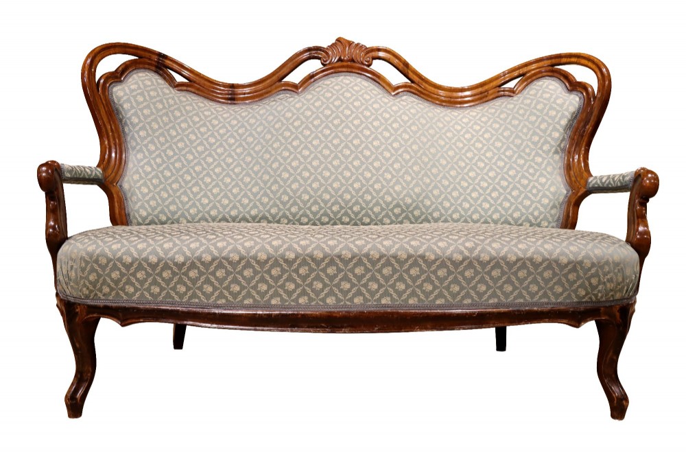 A late 19th-century three-piece walnut salon suite featuring a central settee and two matching armchairs upholstered in patterned sage green fabric with carved serpentine frames. View III