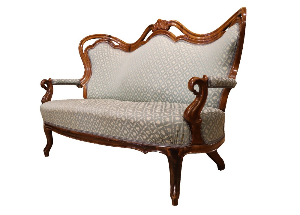 A late 19th-century three-piece walnut salon suite featuring a central settee and two matching armchairs upholstered in patterned sage green fabric with carved serpentine frames. View IV