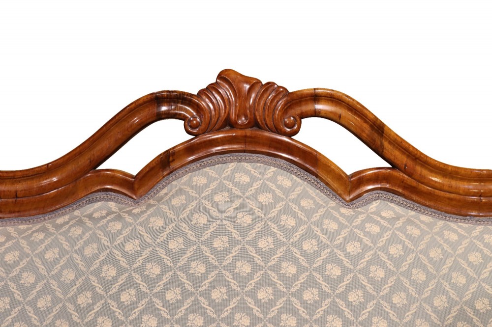 A late 19th-century three-piece walnut salon suite featuring a central settee and two matching armchairs upholstered in patterned sage green fabric with carved serpentine frames. View VII