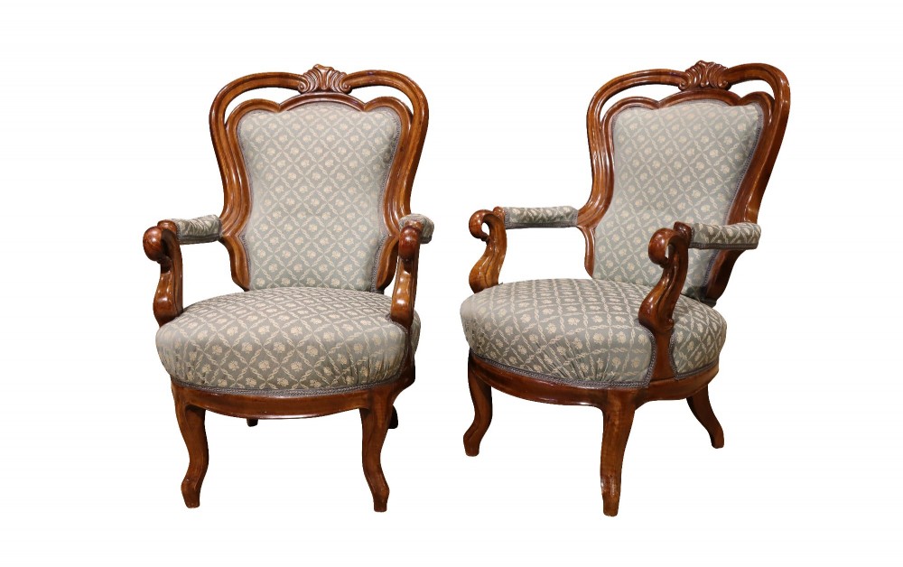 A late 19th-century three-piece walnut salon suite featuring a central settee and two matching armchairs upholstered in patterned sage green fabric with carved serpentine frames. View IX