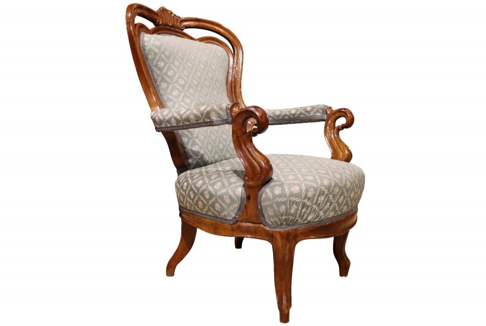 A late 19th-century three-piece walnut salon suite featuring a central settee and two matching armchairs upholstered in patterned sage green fabric with carved serpentine frames. View XII
