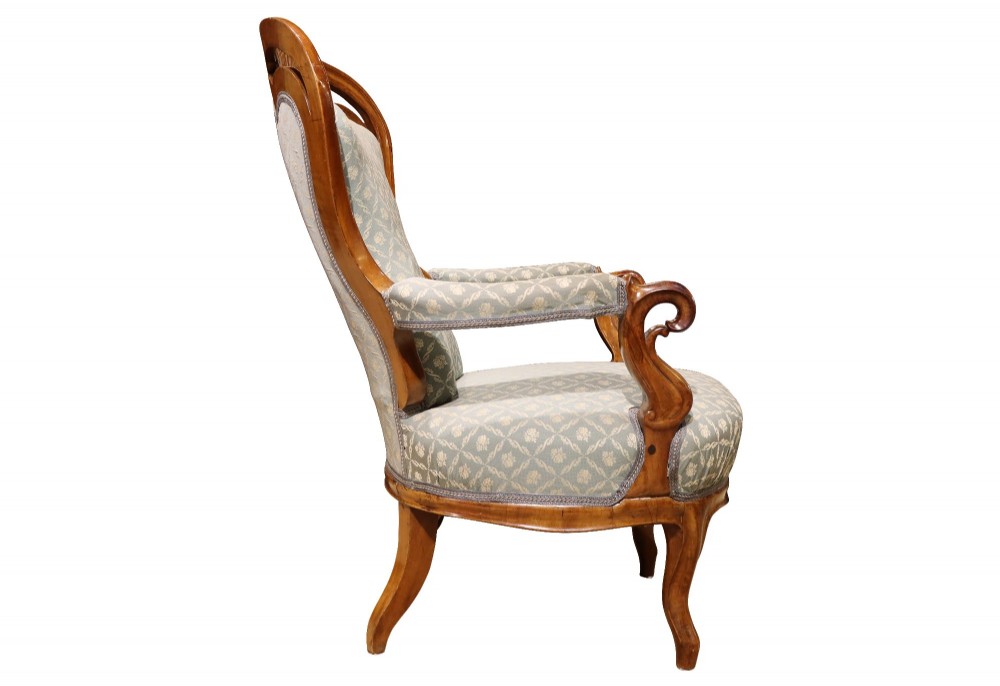 A late 19th-century three-piece walnut salon suite featuring a central settee and two matching armchairs upholstered in patterned sage green fabric with carved serpentine frames. View XIII