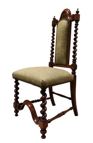 A Victorian walnut childs chair featuring spiralled barley twist uprights, a carved top crest, an upholstered green fabric seat and back, and a shaped front stretcher. View II