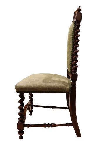A Victorian walnut childs chair featuring spiralled barley twist uprights, a carved top crest, an upholstered green fabric seat and back, and a shaped front stretcher. View III