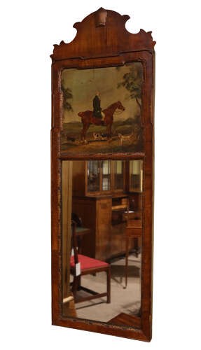 An early 20th-century Queen Anne Revival walnut pier glass mirror featuring a shaped cresting, an upper equestrian oil painting panel, and a tall mirrored pane below. View IV