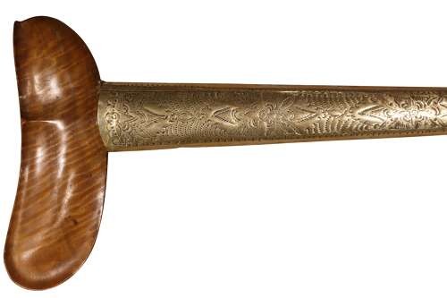 A 19th-century Malay keris featuring a wavy forged steel blade alongside a carved wooden hilt and an ornate brass-encased sheath. View III