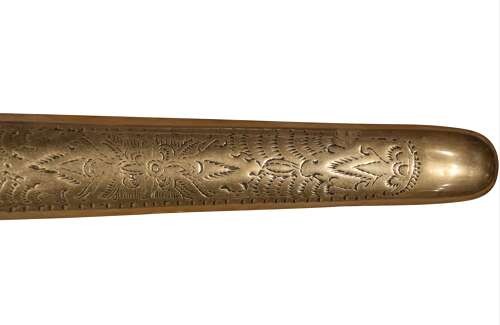 A 19th-century Malay keris featuring a wavy forged steel blade alongside a carved wooden hilt and an ornate brass-encased sheath. View V