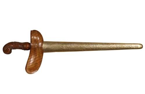 A 19th-century Malay keris featuring a wavy forged steel blade alongside a carved wooden hilt and an ornate brass-encased sheath. View VI
