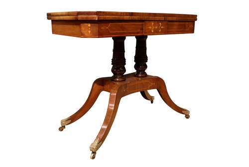 A Regency period rosewood foldover card table featuring marquetry inlay, twin turned pedestals, and four curved legs with brass sabots and castors. View II