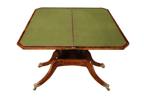 A Regency period rosewood foldover card table featuring marquetry inlay, twin turned pedestals, and four curved legs with brass sabots and castors. View III