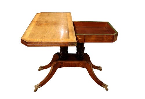 A Regency period rosewood foldover card table featuring marquetry inlay, twin turned pedestals, and four curved legs with brass sabots and castors. View VI