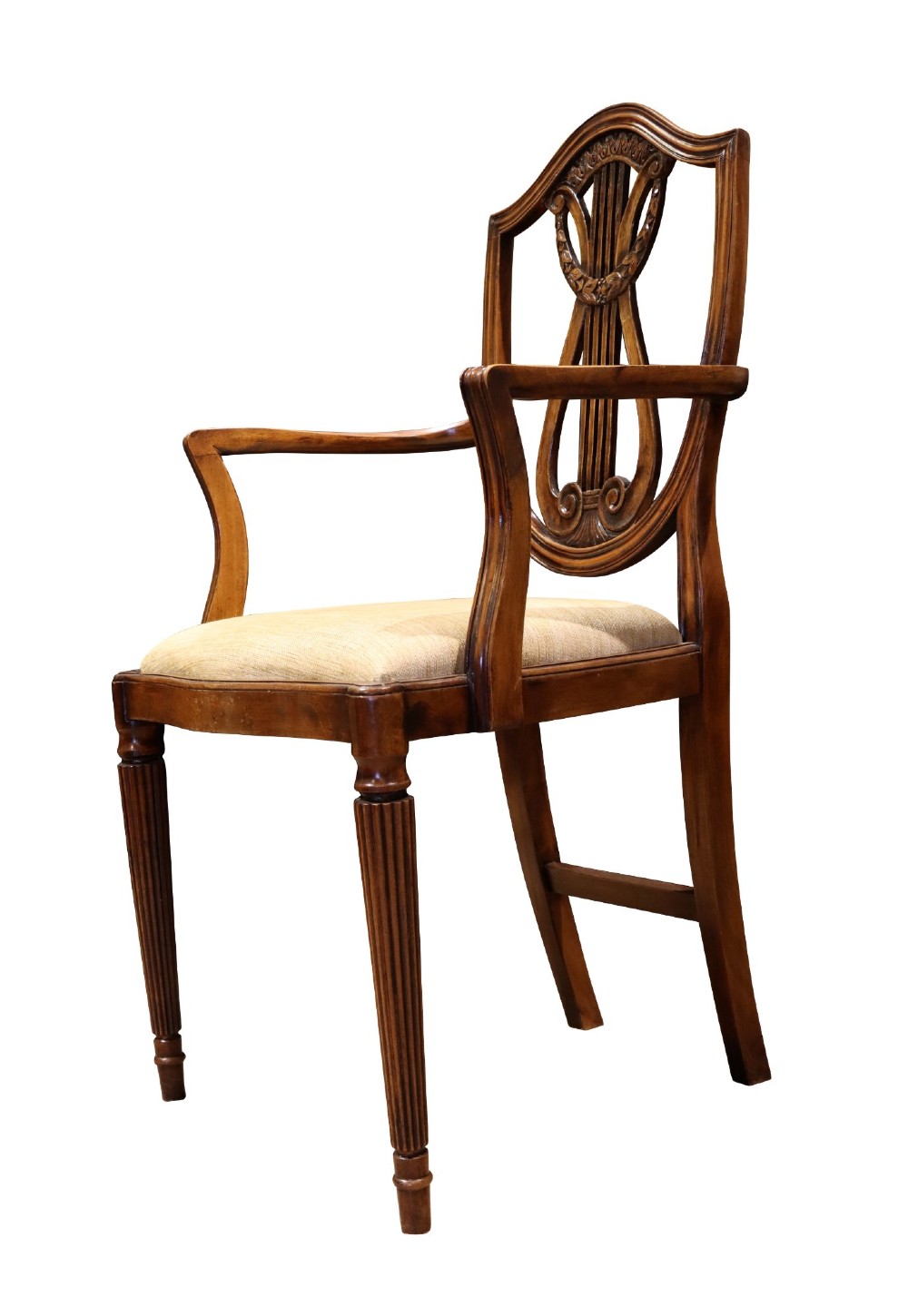 Set of mahogany dining chairs featuring shield-shaped backs with carved lyre motifs, fluted front legs, and neutral upholstered seats. View V