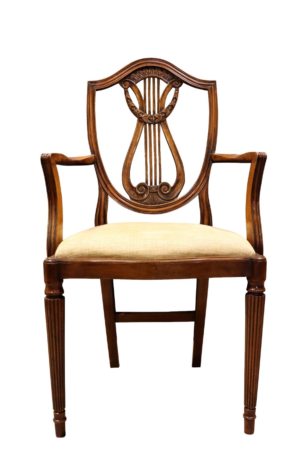 Set of mahogany dining chairs featuring shield-shaped backs with carved lyre motifs, fluted front legs, and neutral upholstered seats. View VI