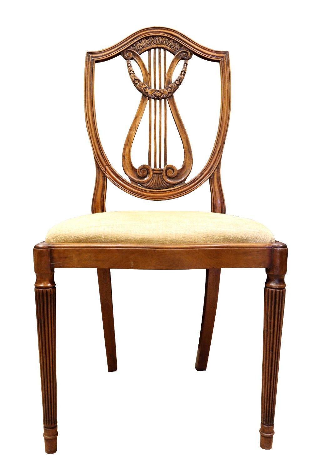 Set of mahogany dining chairs featuring shield-shaped backs with carved lyre motifs, fluted front legs, and neutral upholstered seats. View IX