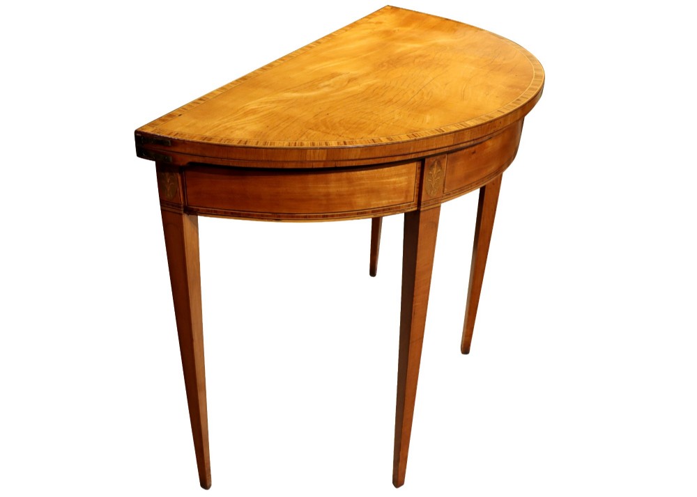A George III satinwood demi-lune card table featuring kingwood crossbanding and square tapered legs. View II