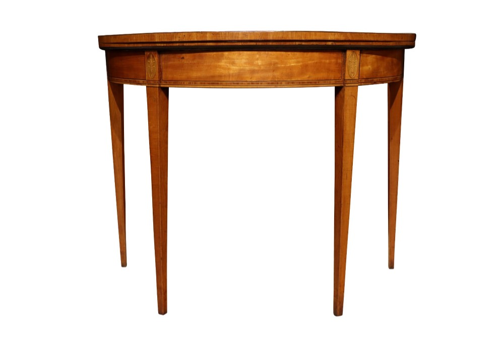 A George III satinwood demi-lune card table featuring kingwood crossbanding and square tapered legs. View VI