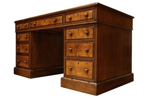A Victorian oak and burr walnut pedestal desk featuring nine drawers with turned wooden knob handles and a central kneehole. View V