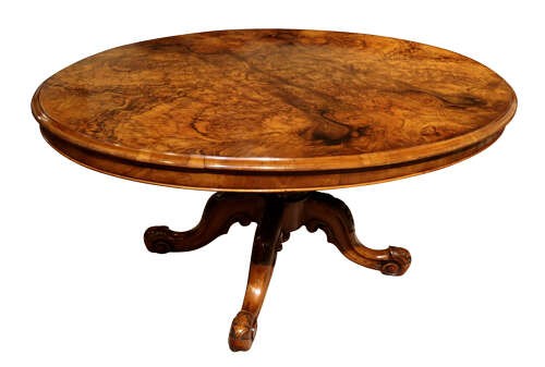 A Victorian oval burr walnut breakfast table featuring rich timber grain and a carved quadrapod base with scroll feet. View II