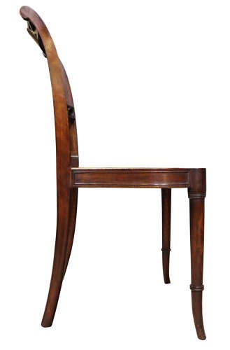 An Edwardian dark mahogany side chair featuring a woven cane seat, pierced lattice splat, and turned front legs. View IV